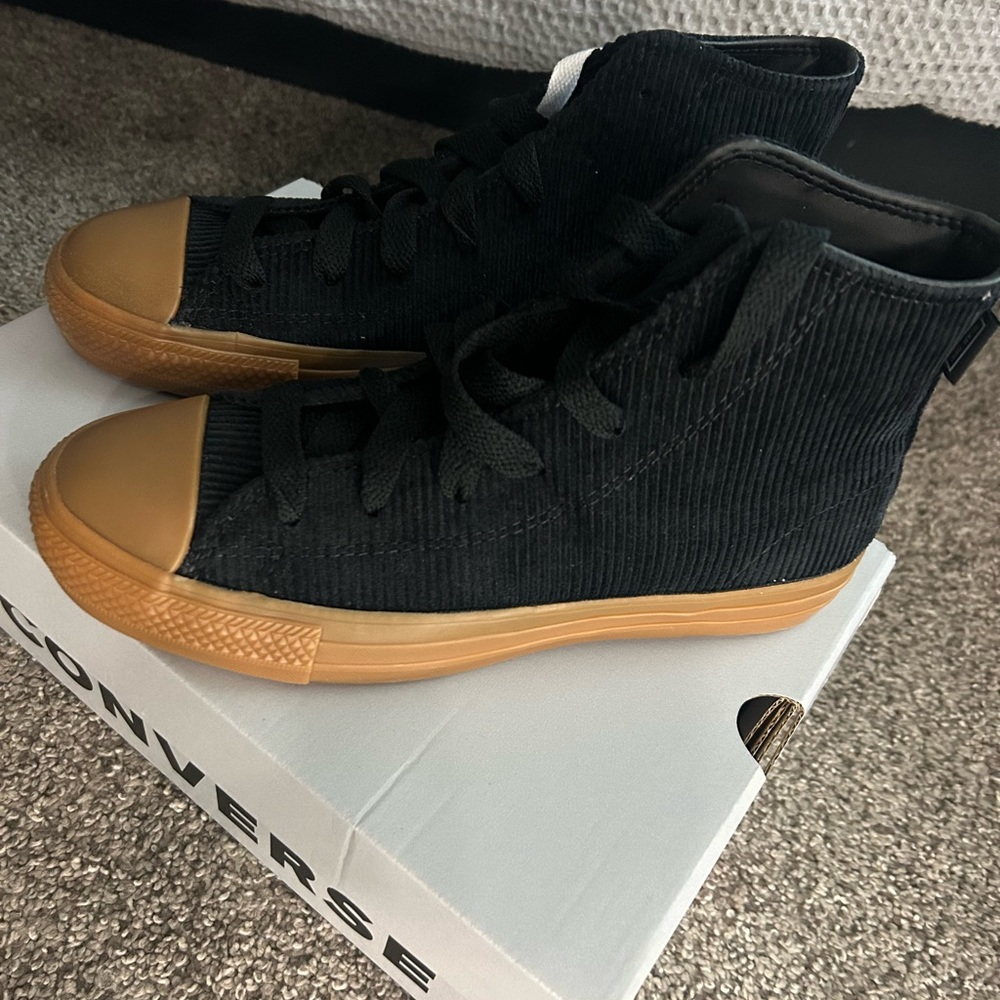 Black suede and brown gummy bottom Converse Chuck Taylor All Stars.